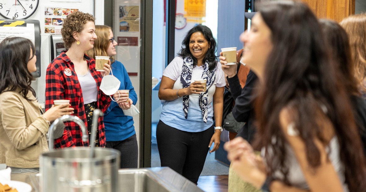 students and Jai standing in global kitchen