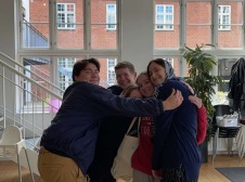 Group photo in building in front of window