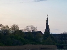 Photo of lake with building silhouette 
