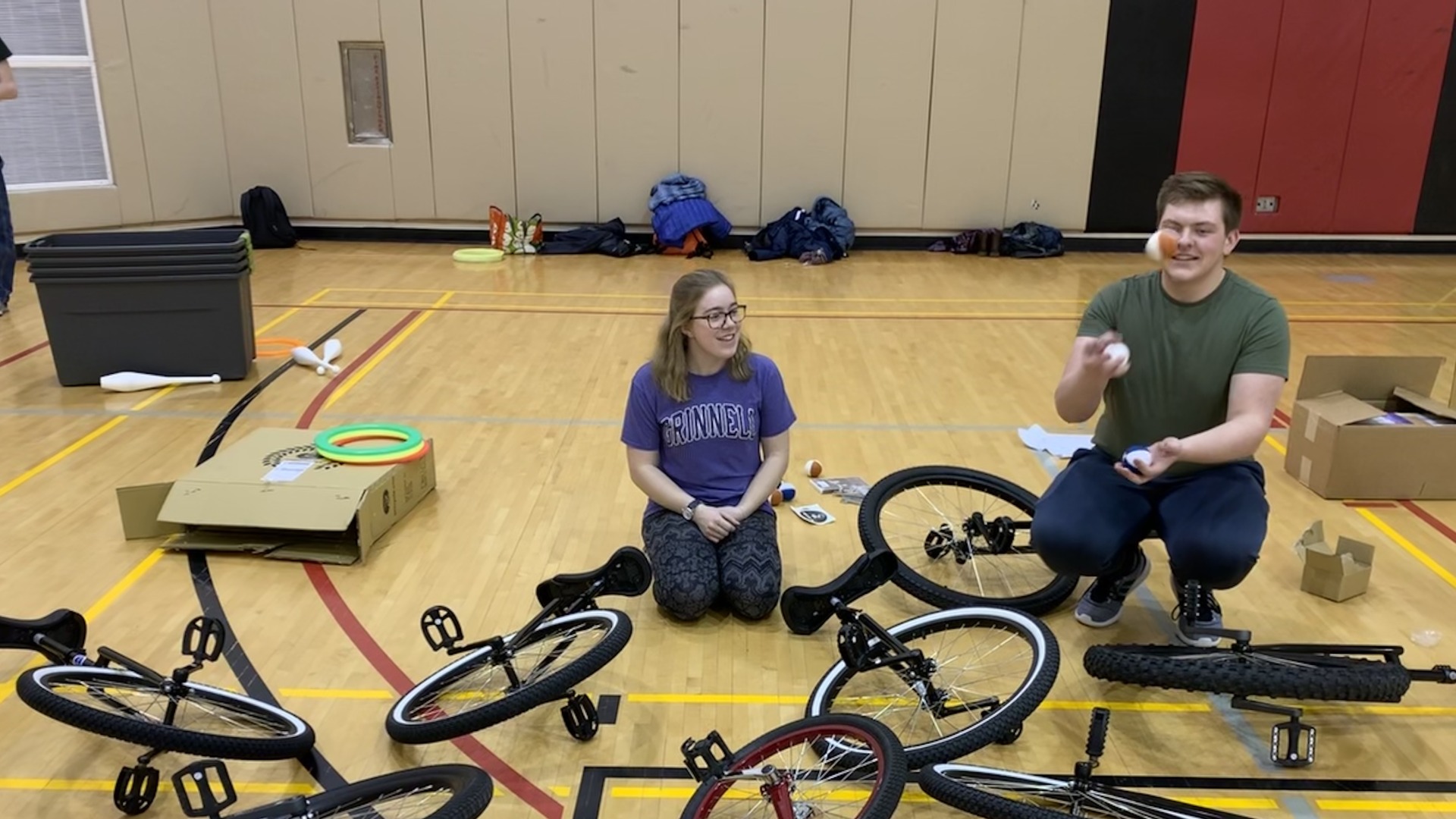 Me standing next to unicycles