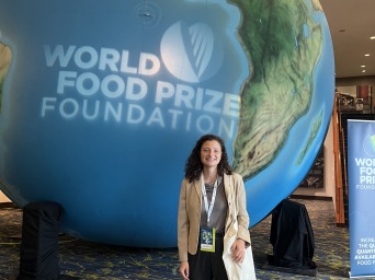 I stand next to a giant globe with the words "World Food Prize Foundation."