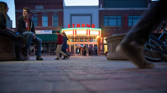 Strand 3 Movie Theatre exterior with lights on at dusk
