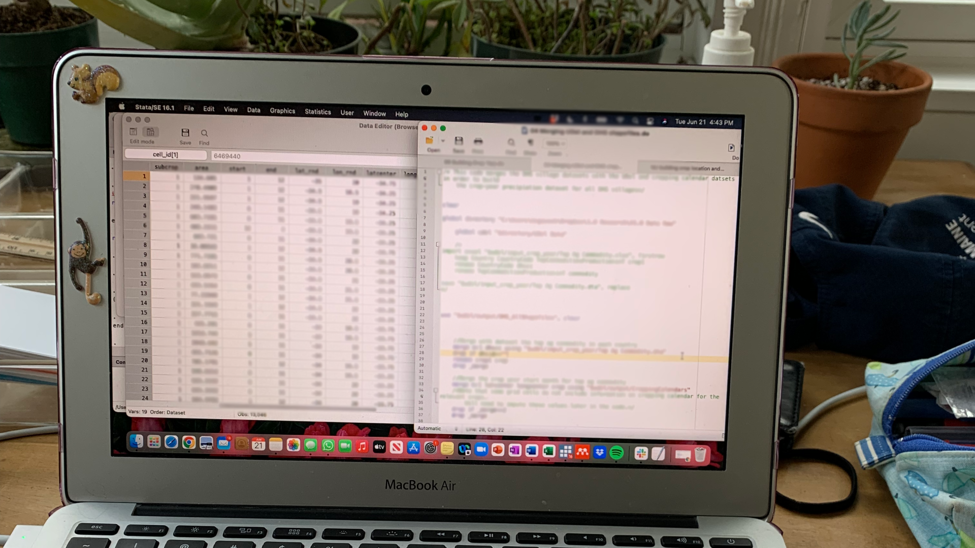 A laptop is open with the screen reflecting multiple points of data and code.