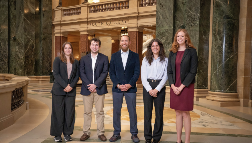 Four students interns stand in the rotunda of the Wisconsin State Capitol